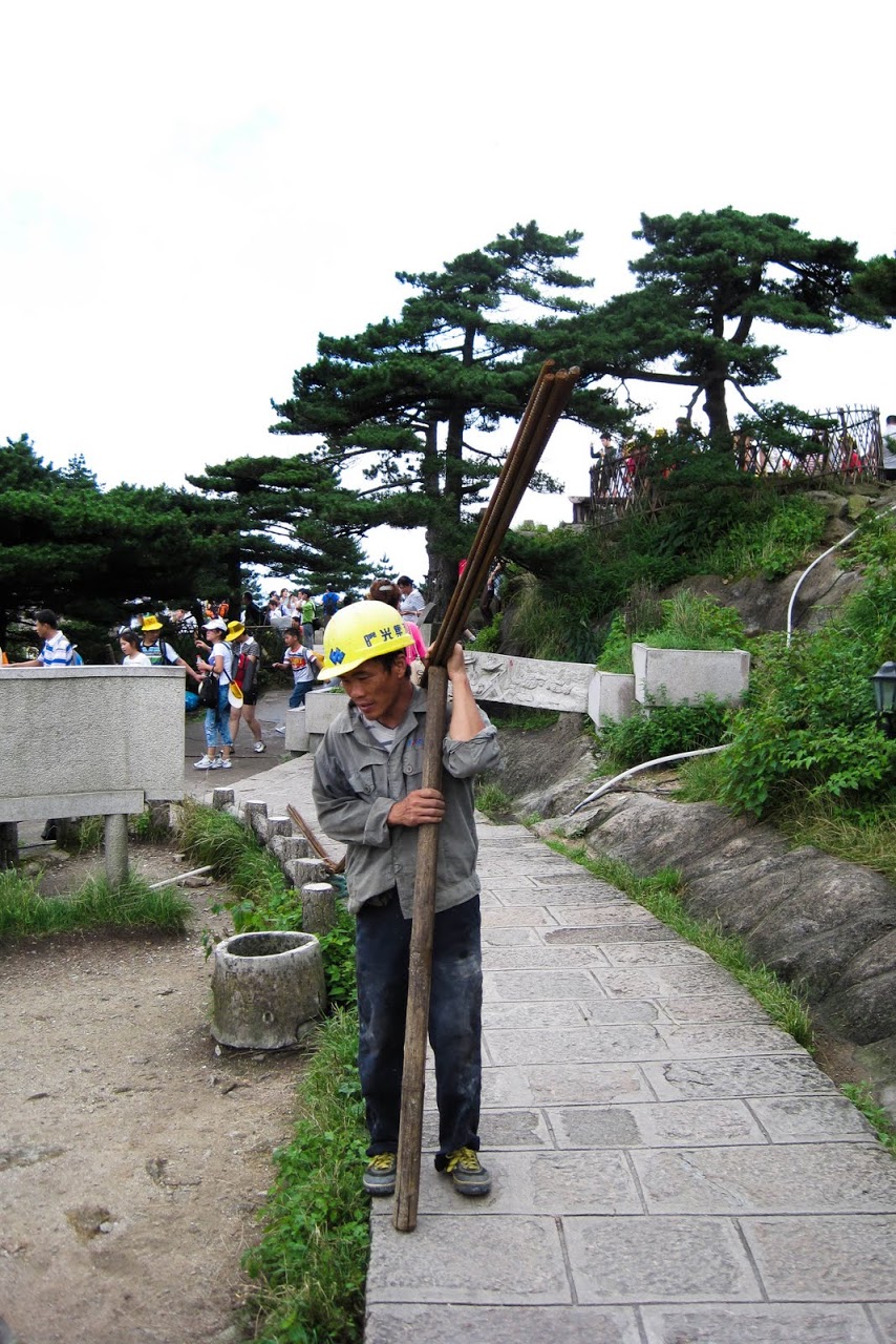 Guy carrying a pole