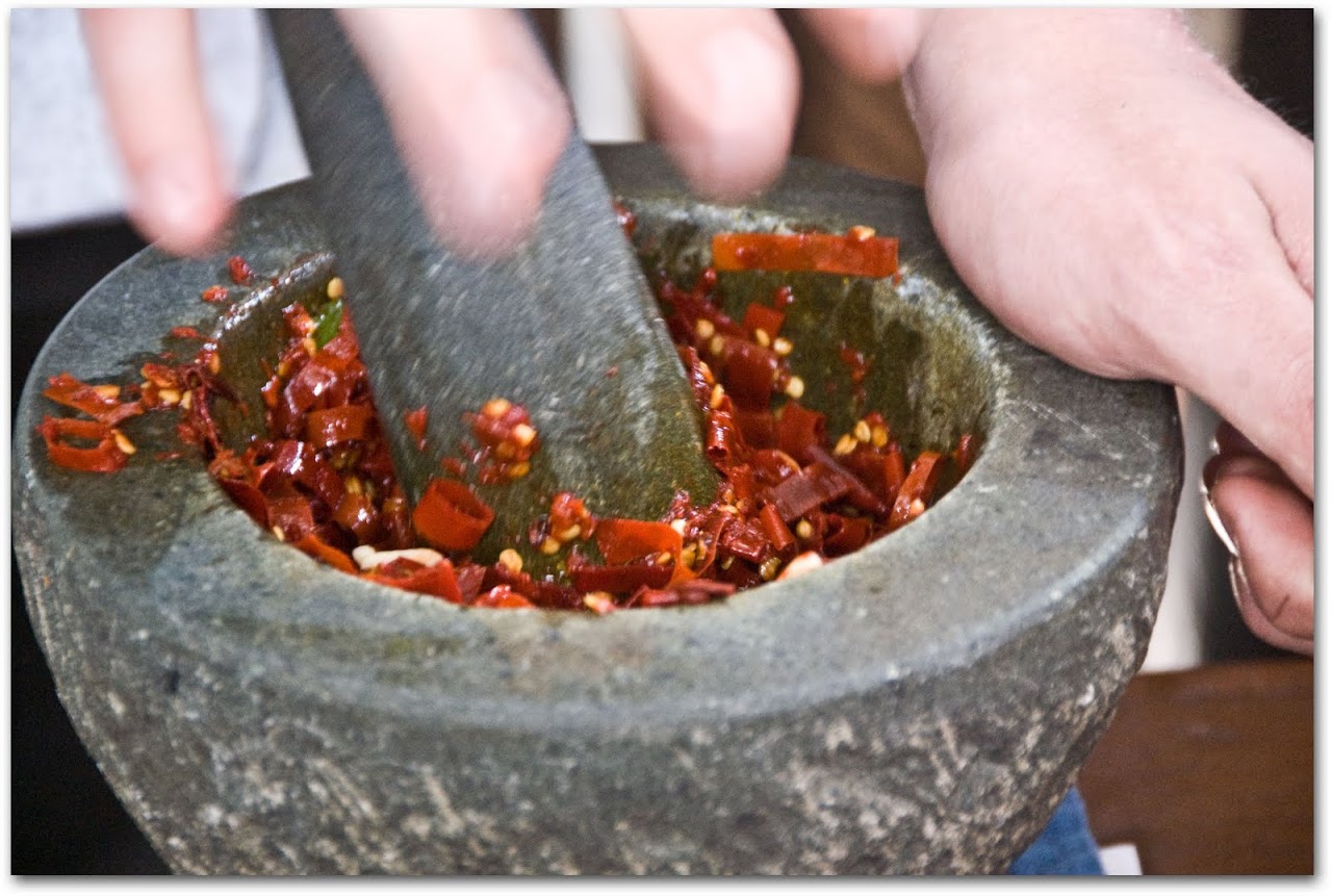 Grinding red curry paste